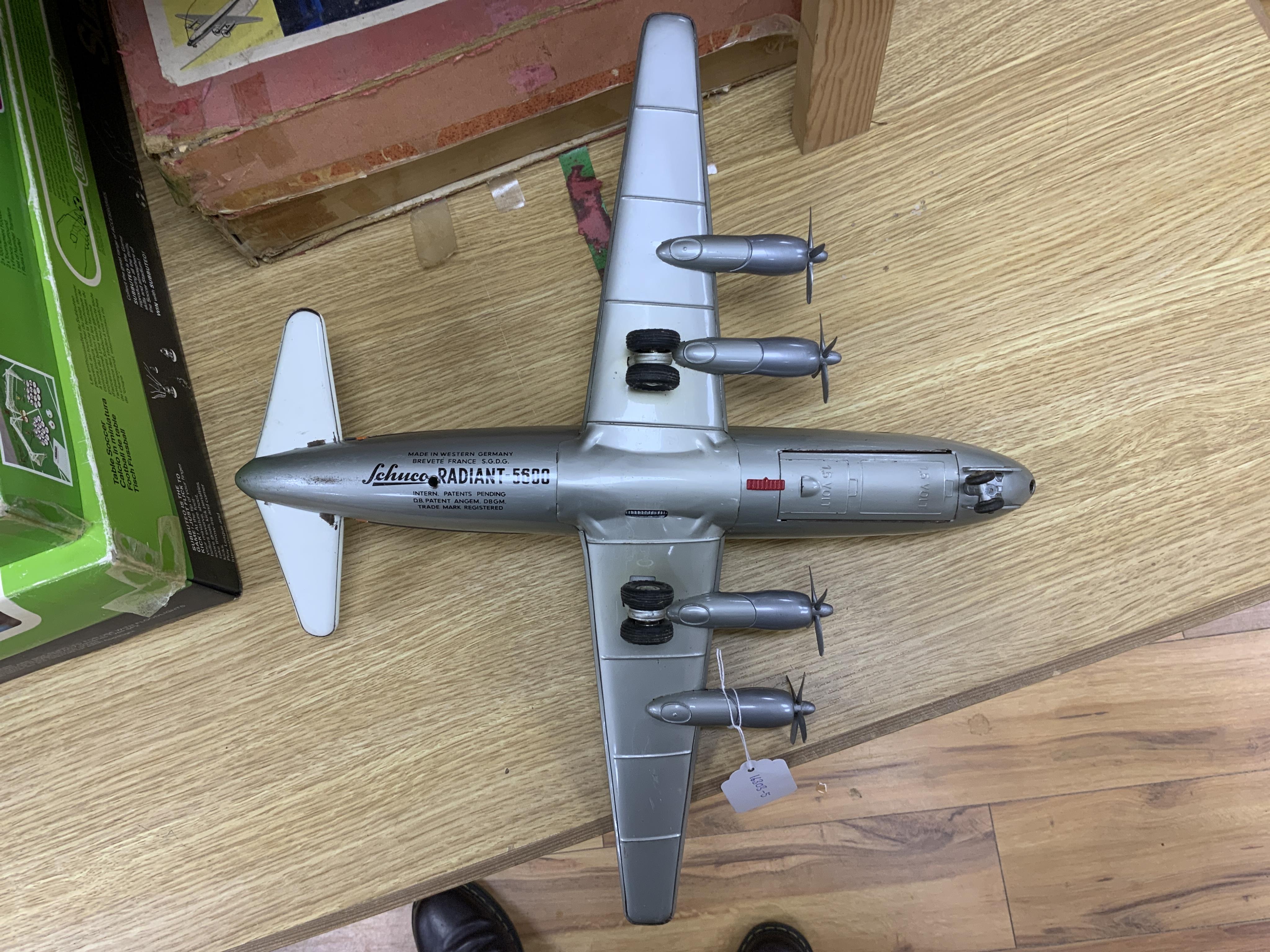 A boxed Schuco Elektro Radiant 5600 battery operated tinplate BOAC passenger aircraft, with instruction leaflet and steering wheel. Condition - poor to good, wear and damage to box and some tape repairs, aircraft general